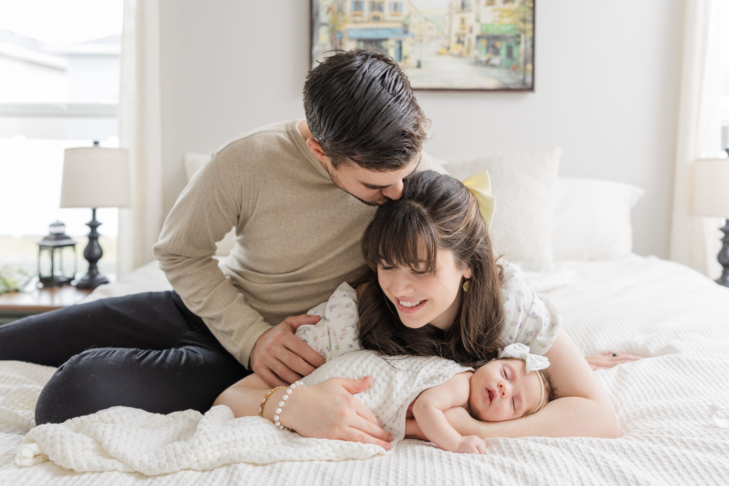 Boise newborn photographer capturing parents cuddling baby during in-home session