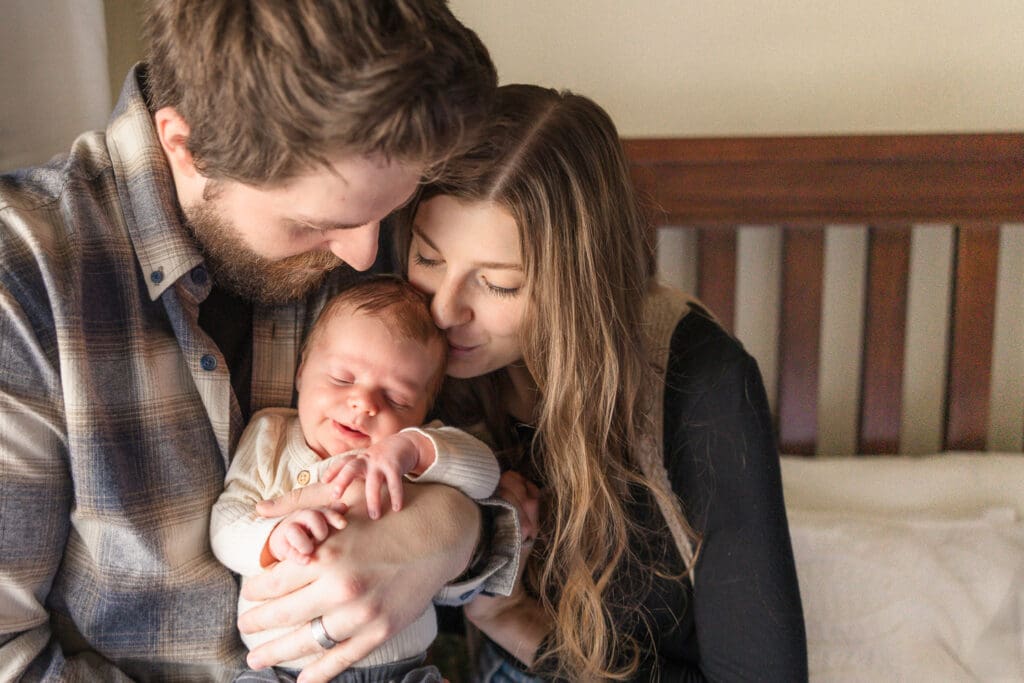 Parents holding newborn during Emmett in-home newborn session