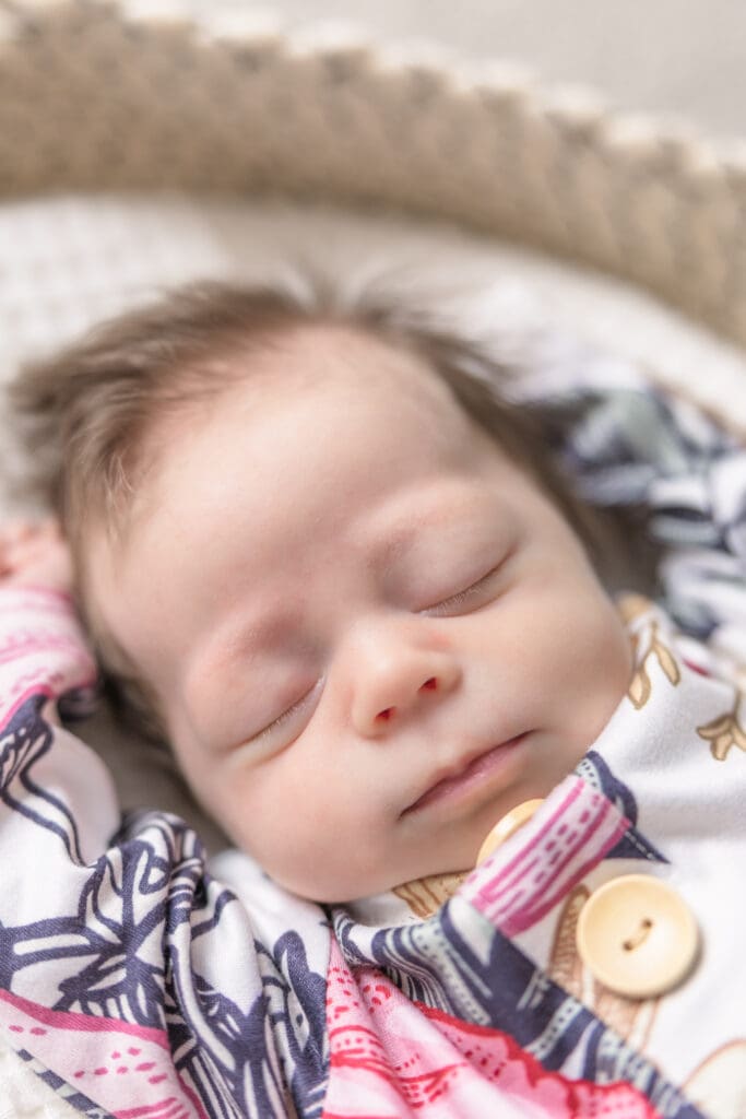 Peaceful newborn sleeping with tiny hands near head