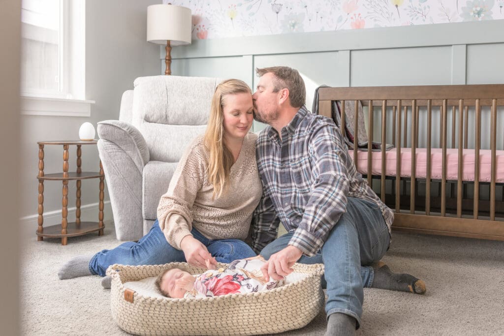 Parents beside newborn during lifestyle Nampa newborn photography session