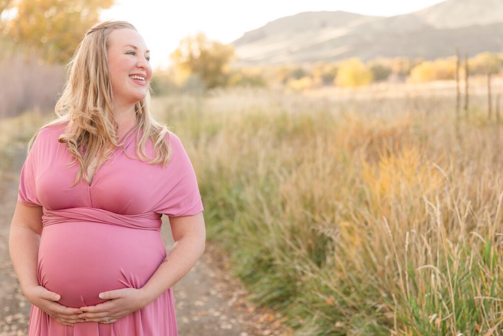 Maternity photo during spring family photoshoot near Emmett in open field