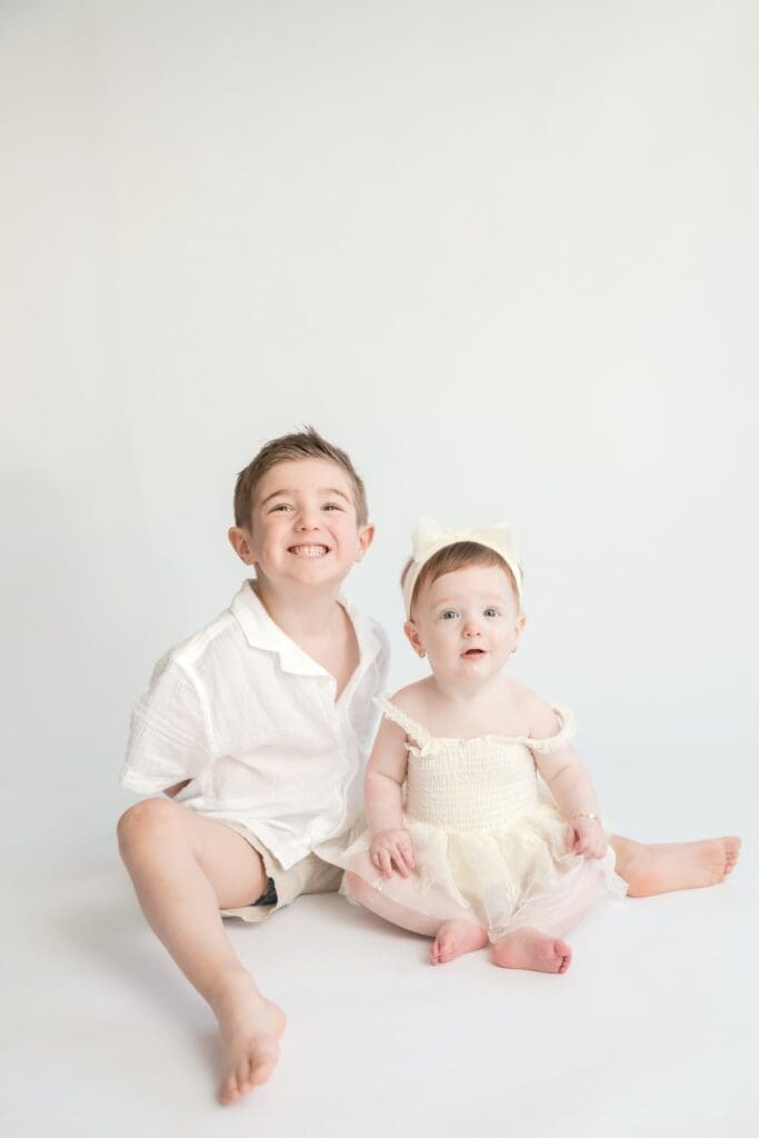Brother and baby sister portrait during studio family photography session