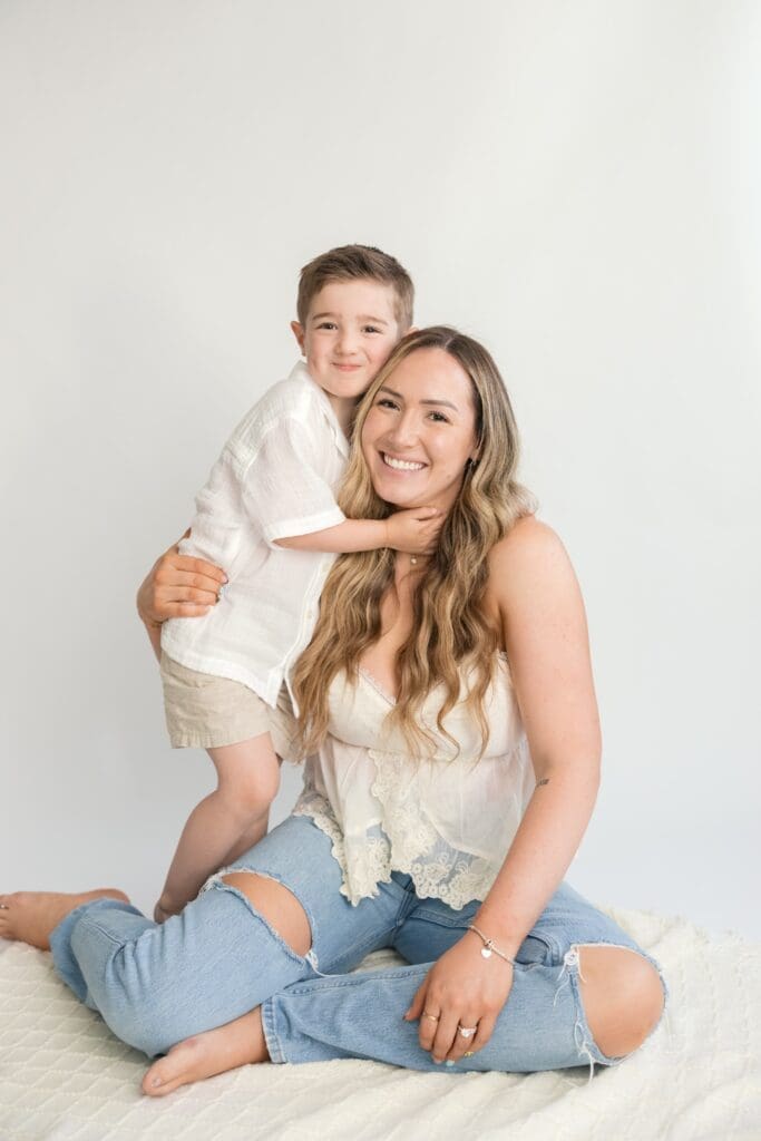 Studio mother and son portrait with soft neutral backdrop